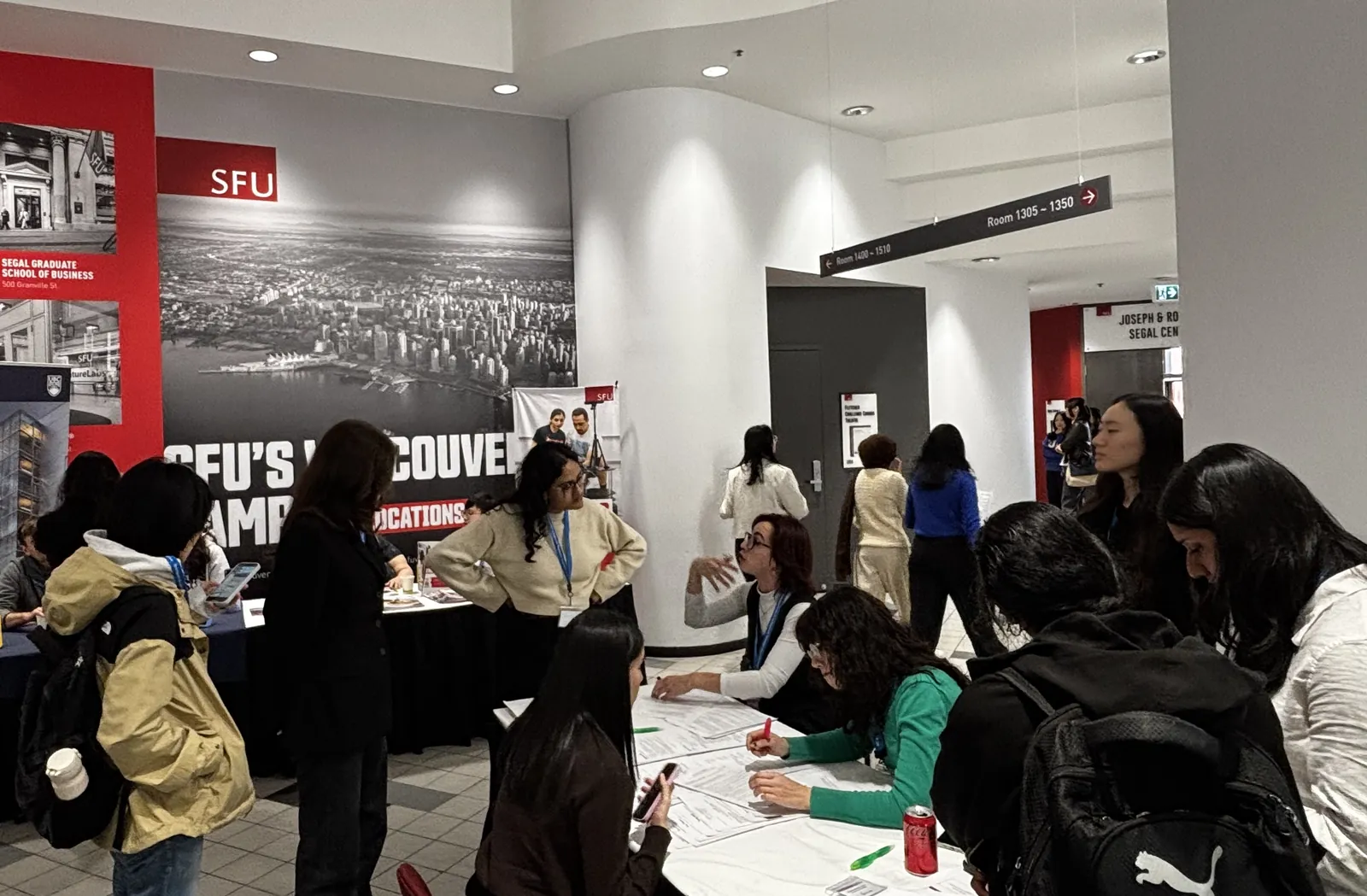 Attendees checking in at the registration desk at SFU Harbour Centre during CAN-CWiC West 2025