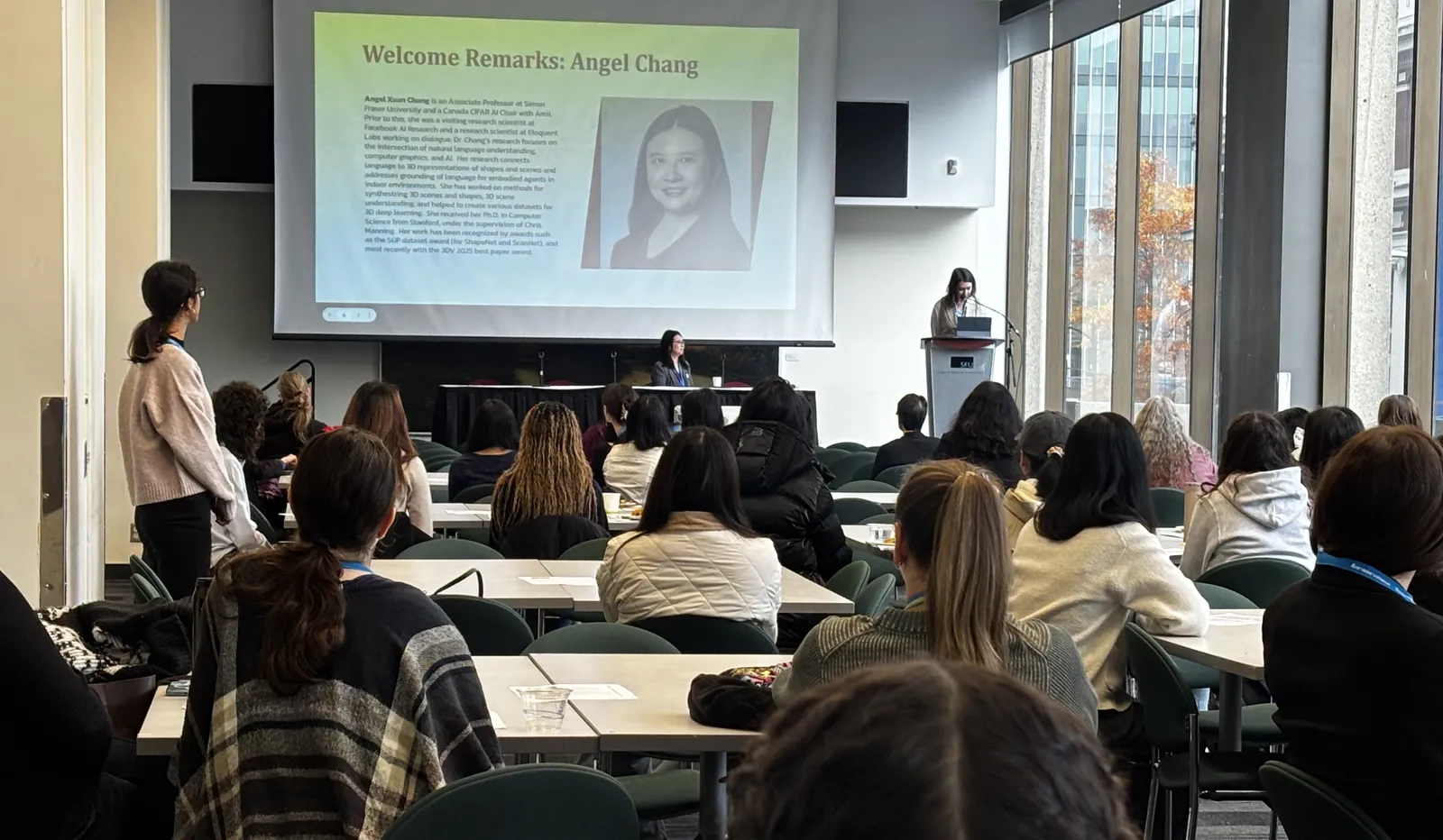 Attendees listening to welcome remarks by Angel Chang at CAN-CWiC West 2025