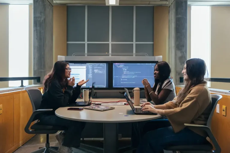 Computer science students collaborating at dual monitors at Dalhousie University